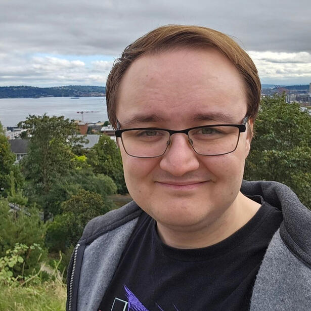 Photo of Derek L.H. standing in front of Kerry Park in Seattle, Washington.